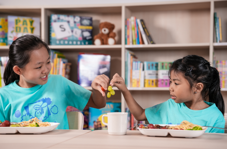 Two student sharing a meal during lunch break at Changemakers